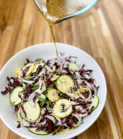 A bowl of refreshing zucchini salad with radicchio, feta cheese, and mint.