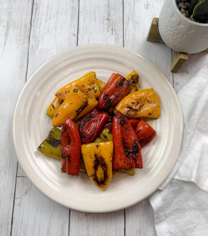 Final plate of pan roasted mini sweet peppers, brightly colored and perfectly charred.