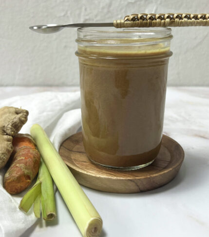 A jar filled with vibrant Lemongrass Salad Dressing, ready to enhance your salads with its refreshing flavors.