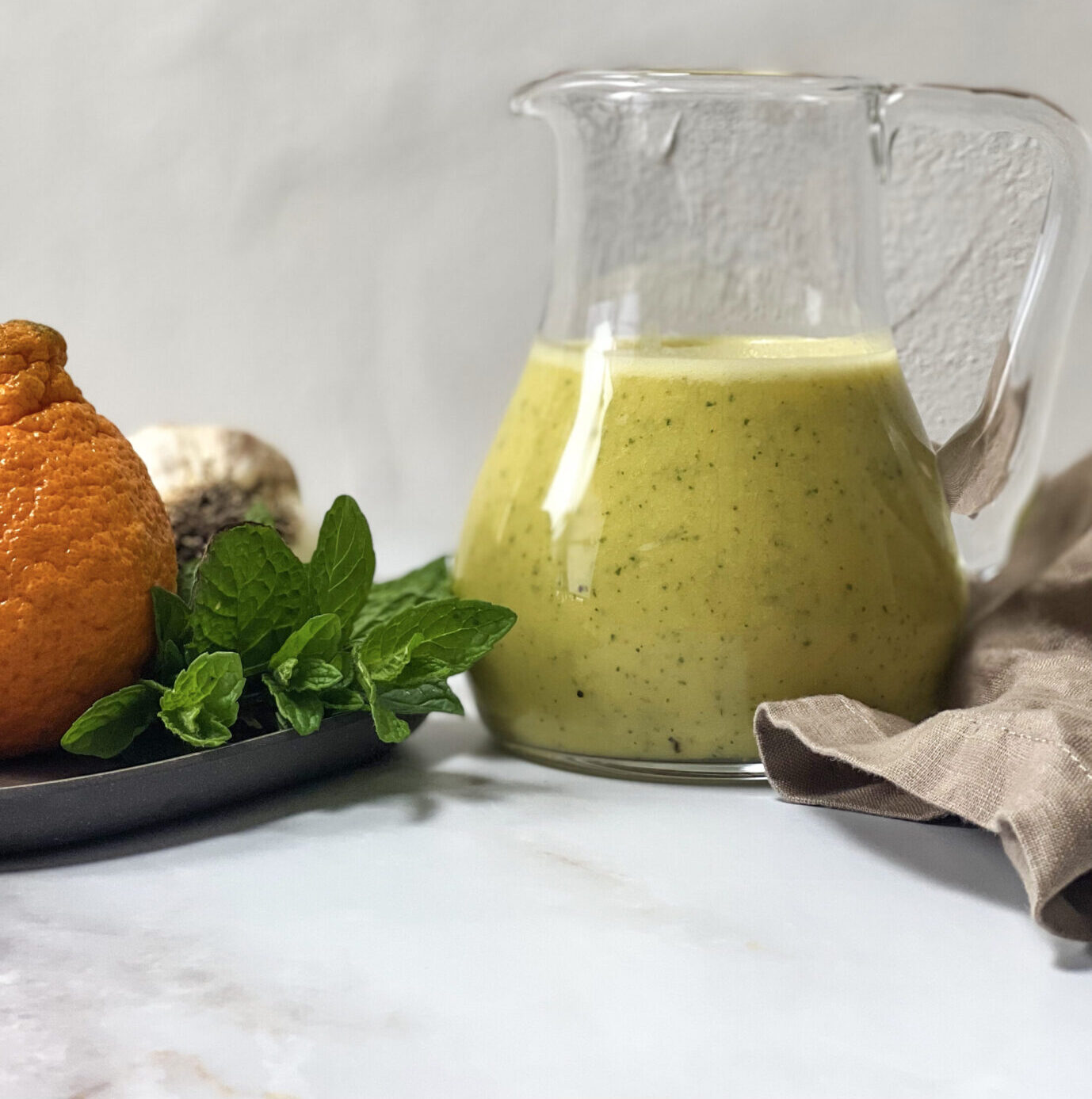 A jar of homemade Mandarin Vinaigrette salad dressing.