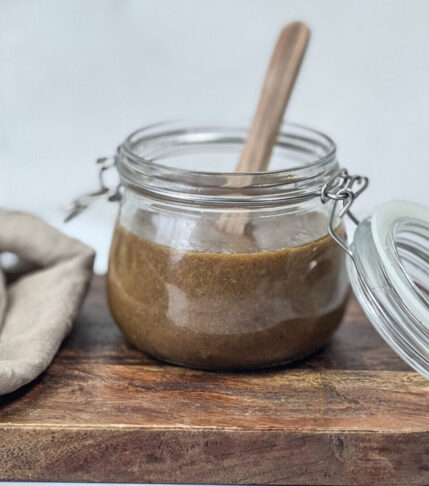 A jar filled with homemade Dijon Balsamic Dressing.
