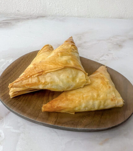 Delicious homemade Spanakopita triangles - Greek spinach pie.