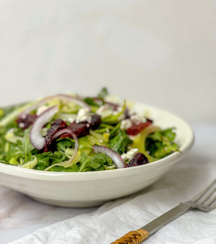 Arugula Fennel Orange and Goat Cheese Salad on a white plate