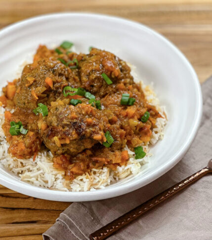 Plate of Meatballs with Fresh Tomato Sauce served over spaghetti.