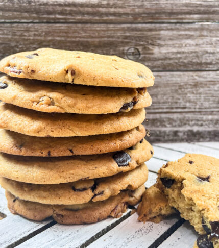 A stack of freshly baked Tahini Pecan Chocolate Chip Cookies on a plate.