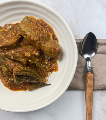 A close-up view of Bamia Delight – a Middle Eastern okra stew with tender lamb, crispy-fried okra, and aromatic spices.