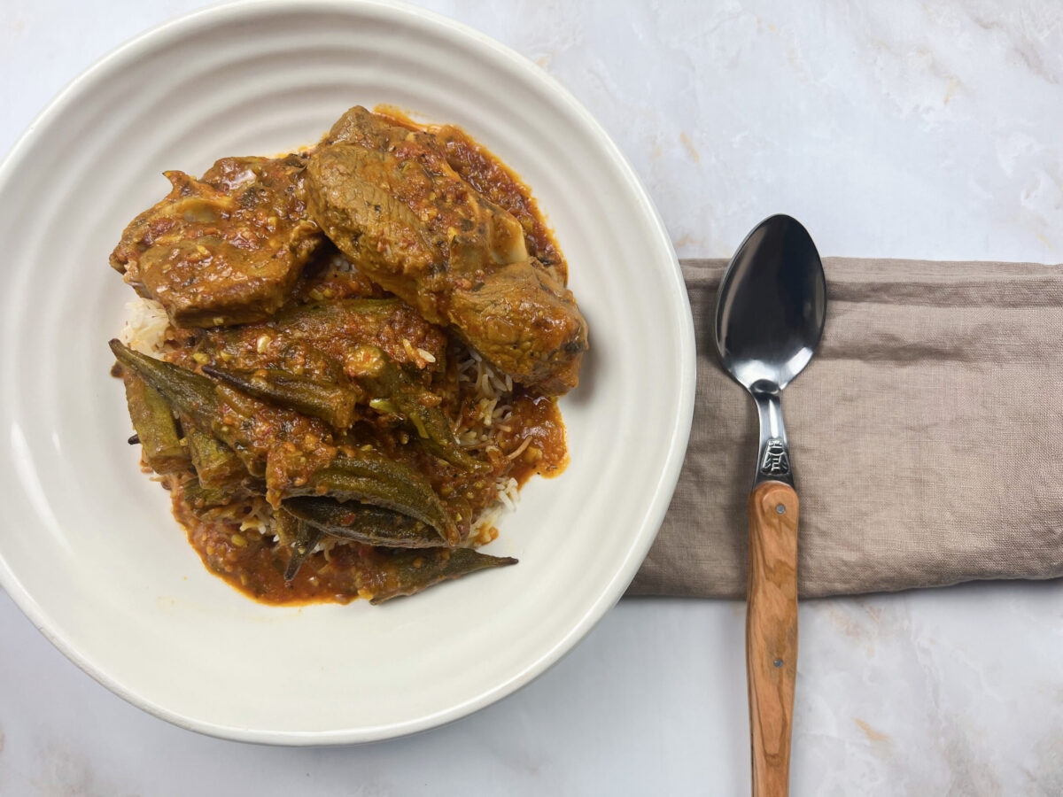 A close-up view of Bamia Delight – a Middle Eastern okra stew with tender lamb, crispy-fried okra, and aromatic spices.