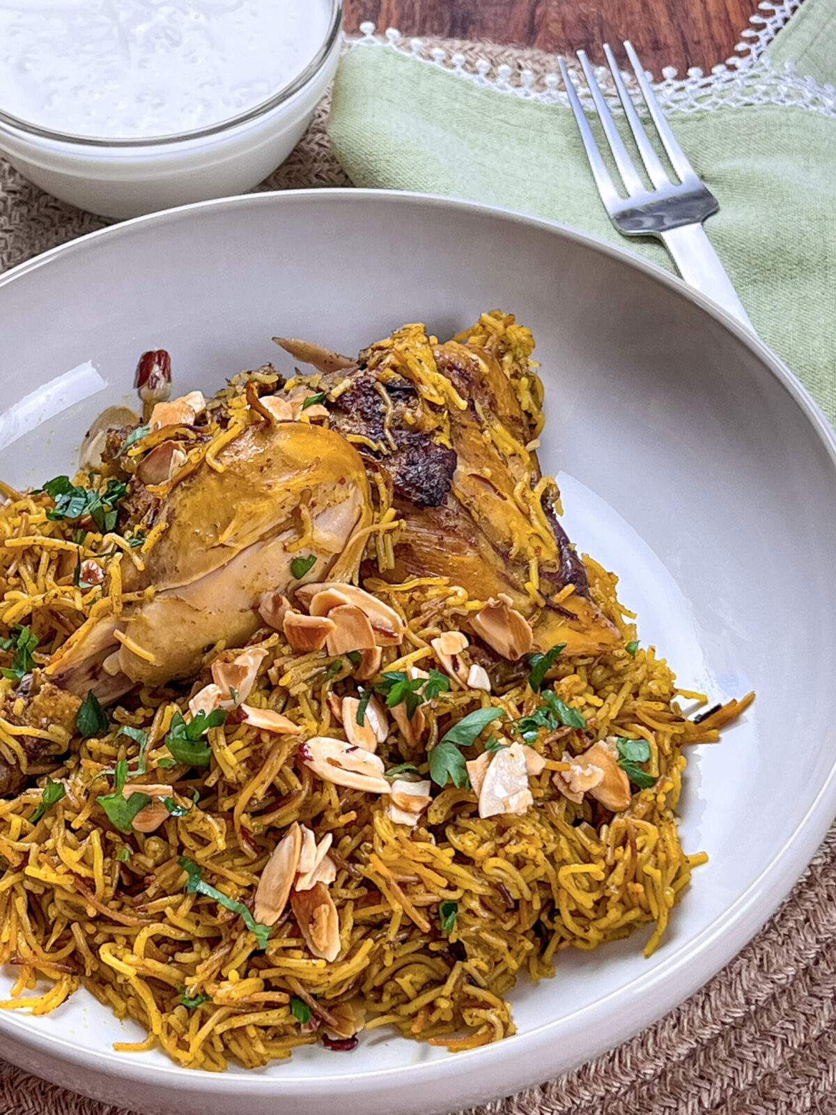 A plate of golden vermicelli noodles topped with seasoned chicken pieces, reflecting traditional Middle Eastern flavors.