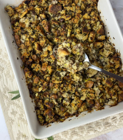 Golden-browned turkey stuffing garnished with herbs.