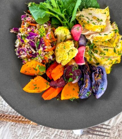 A beautifully plated dish of oven-roasted vegetables, bursting with vibrant colors and flavors.