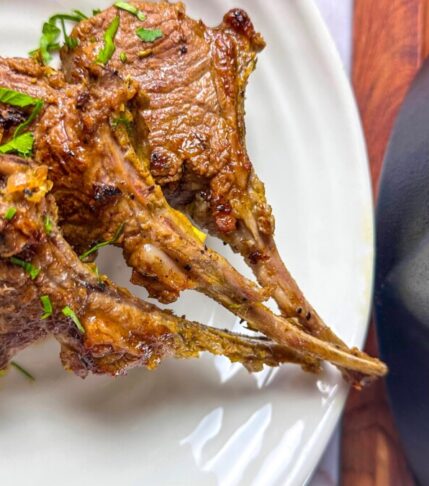 Perfectly Cooked Lamb Chops on a Plate with Garnish