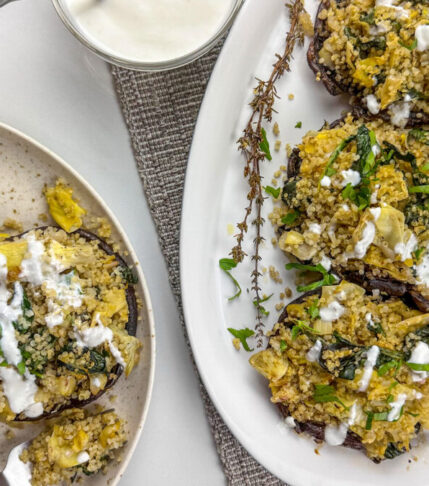 A platter of stuffed portobello mushrooms with quinoa and spinach.