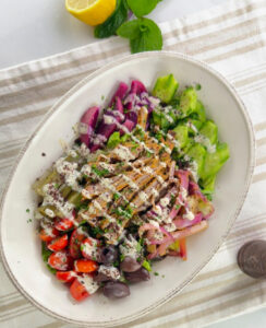 Lamb Salad Shawarma platter drizzle with tahini sauce .