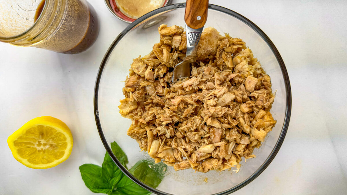 A bowl of tuna being marinated with the freshly prepared balsamic, olive oil, and lemon juice marinade.