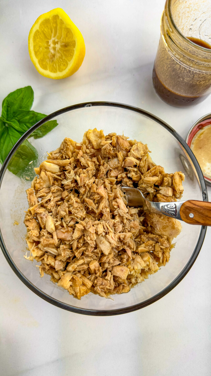 A bowl of tuna being marinated with the freshly prepared balsamic, olive oil, and lemon juice marinade.