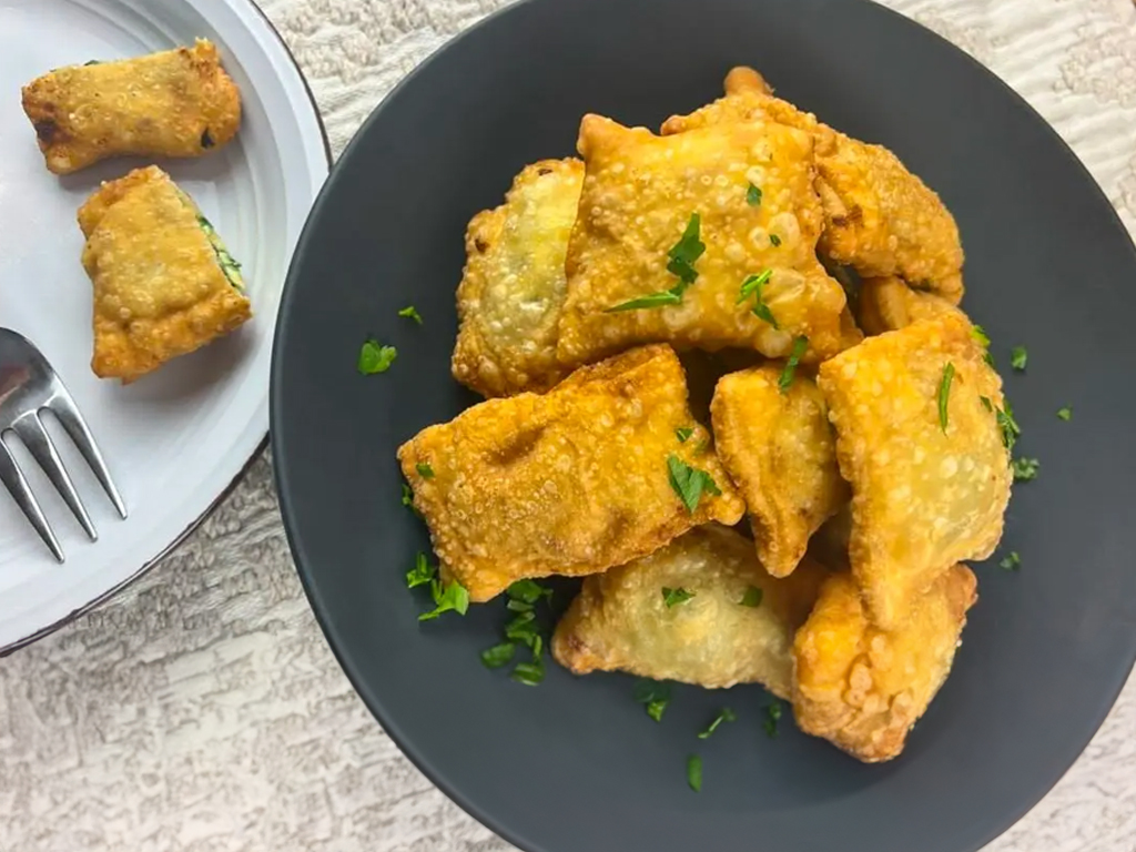  beautifully plated Barbajuan, a Mediterranean Cuisine appetizer known for its savory filling wrapped in delicate, crispy pastry.