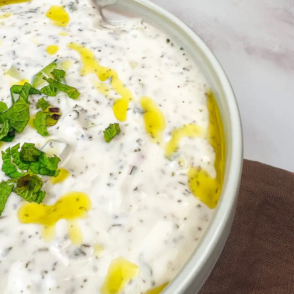 Bowl of Creamy Yogurt Cucumber Salad, a refreshing Mediterranean dish perfect for a collection of 17 delightful Mediterranean salads.