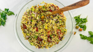 Bowl filled with colorful Greek Orzo Salad, showcasing the blend of orzo pasta, fresh vegetables, feta cheese, and tangy dressing.