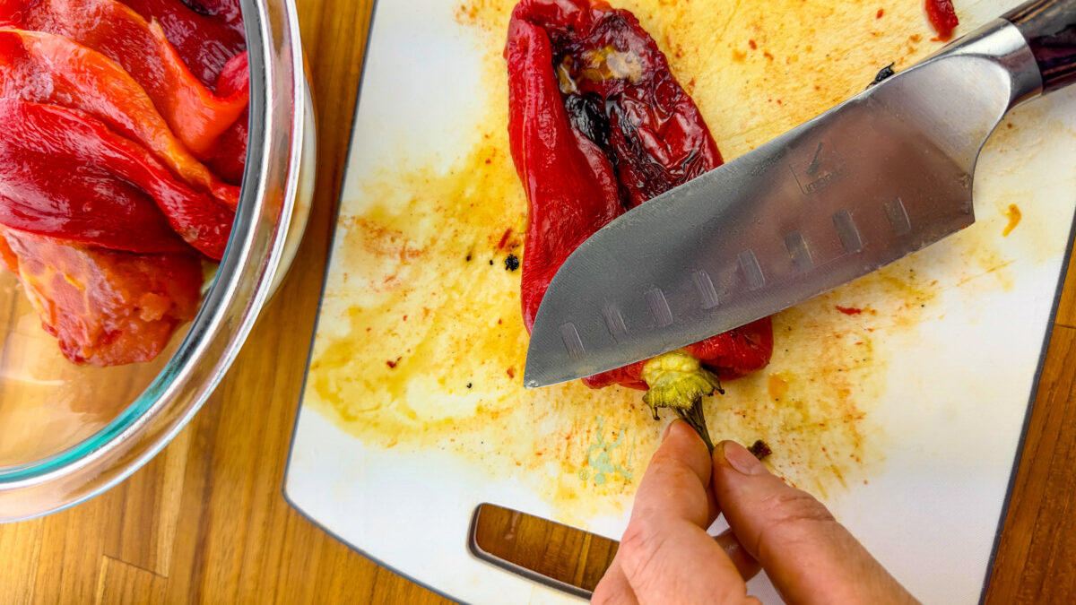 Peeling the charred skin off roasted bell peppers and tomatoes.