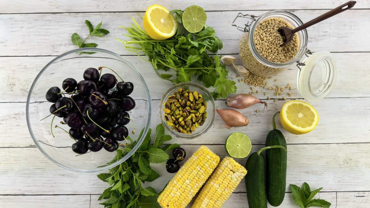 ngredients for Mediterranean-Style Pearl Barley Salad, including cherries, corn, fresh herbs, and measured pearl barley.