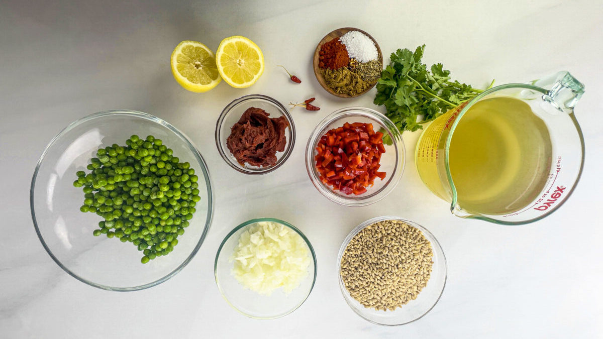 Ingredients spread out for preparing a farro salad recipe with green beans and red bell peppers.