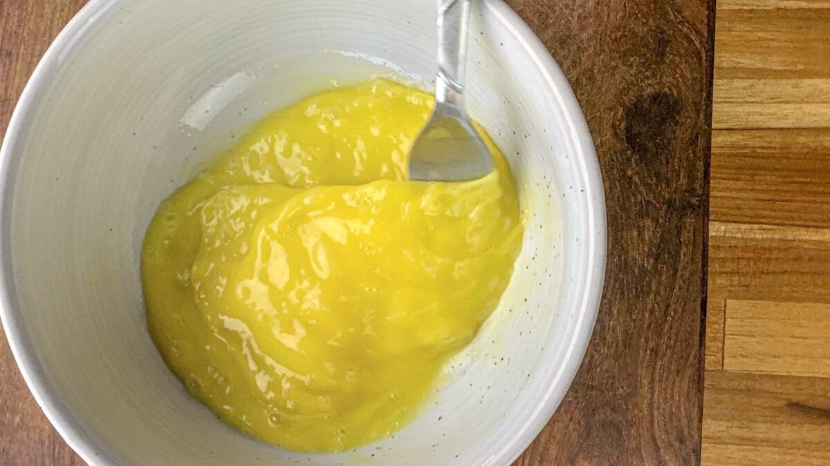 Mixing eggs for tempering, a crucial step in the creation of creamy Avgolemono Soup.