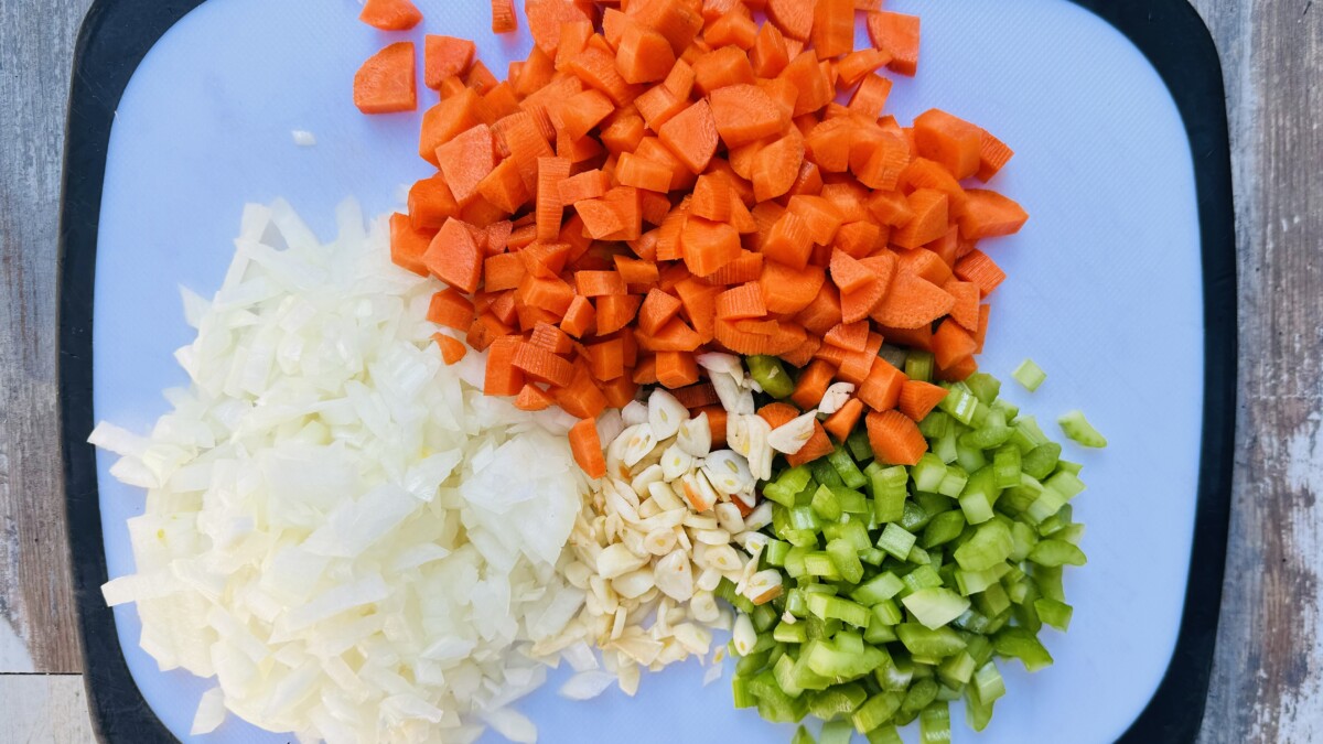 Vibrant medley – Chopped onions, carrots, celery, and garlic, prepped for Gigantes Plaki