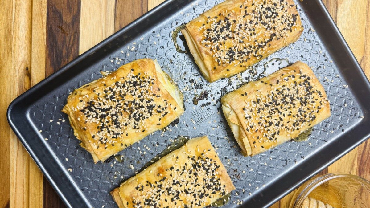 Baked feta wrapped in crispy phyllo, drizzled with honey and sprinkled with toasted black and brown sesame seeds.