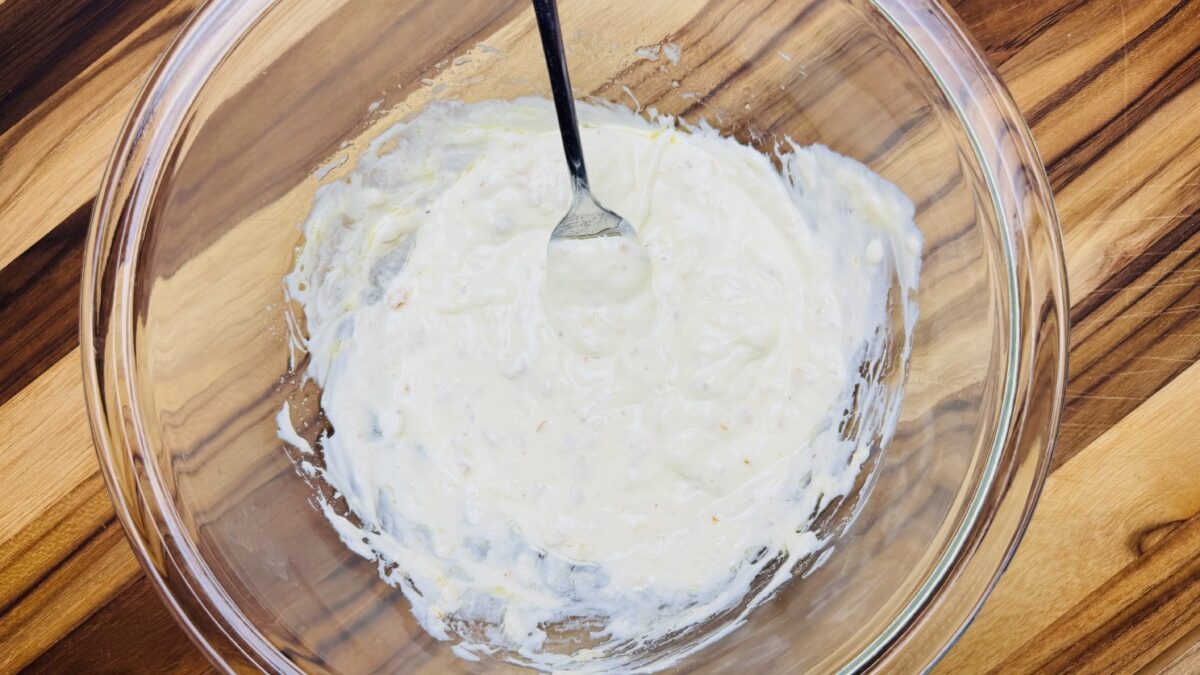 Creamy yogurt-preserved lemon dressing in a bowl, smooth and ready to be added to the Mediterranean Bulgur Salad.