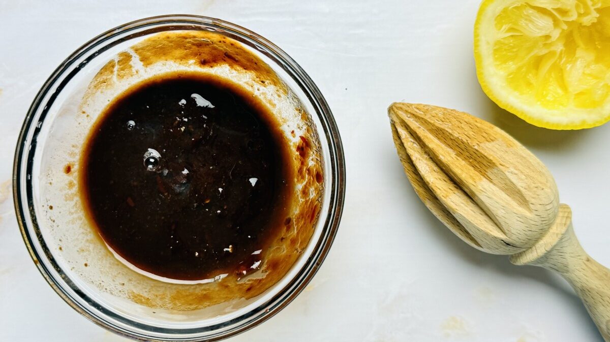 Harissa, pomegranate molasses, and instant coffee being mixed together as flavor boosters for Arayes meat filling.
