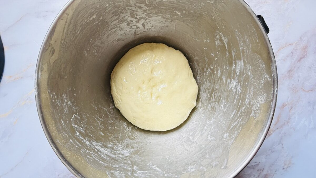 Smooth, kneaded dough placed in a bowl, ready to rise for sfeeha preparation.