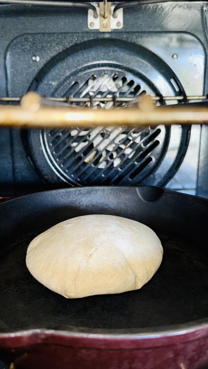 Homemade pita bread puffing up while cooking in the hot oven.