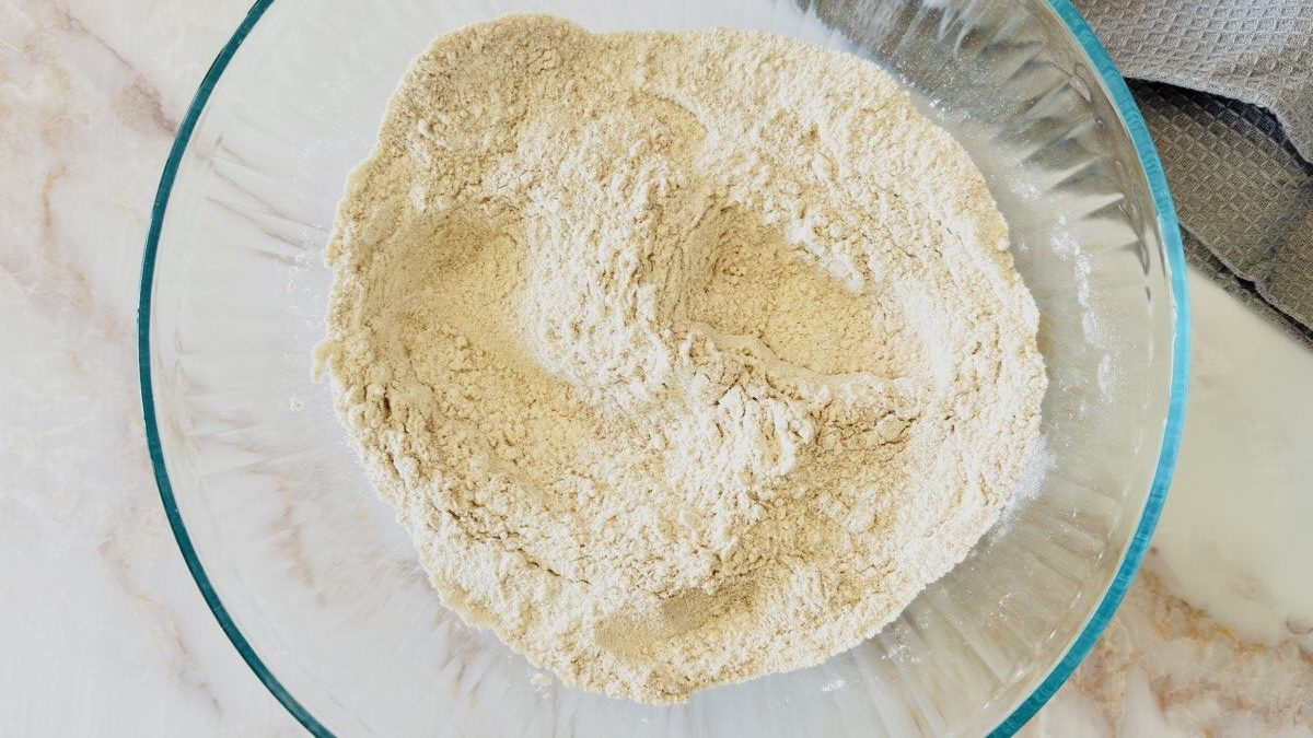 Measuring flour, yeast, sugar, and salt for homemade pita bread dough.