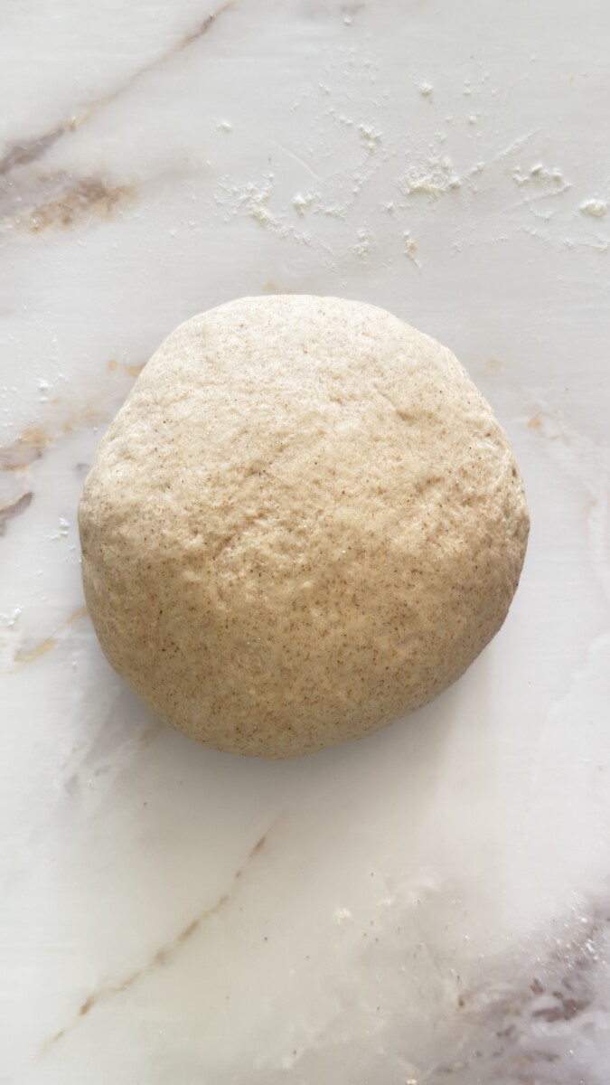 Smooth and elastic pita bread dough after kneading, ready to rise.