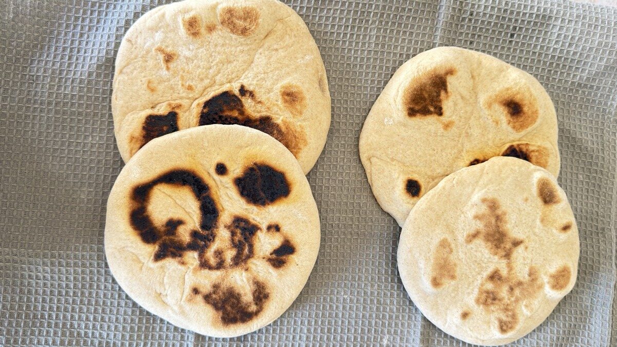 title="Stovetop Pita Bread with Light Puffing in Cast Iron Skillet"