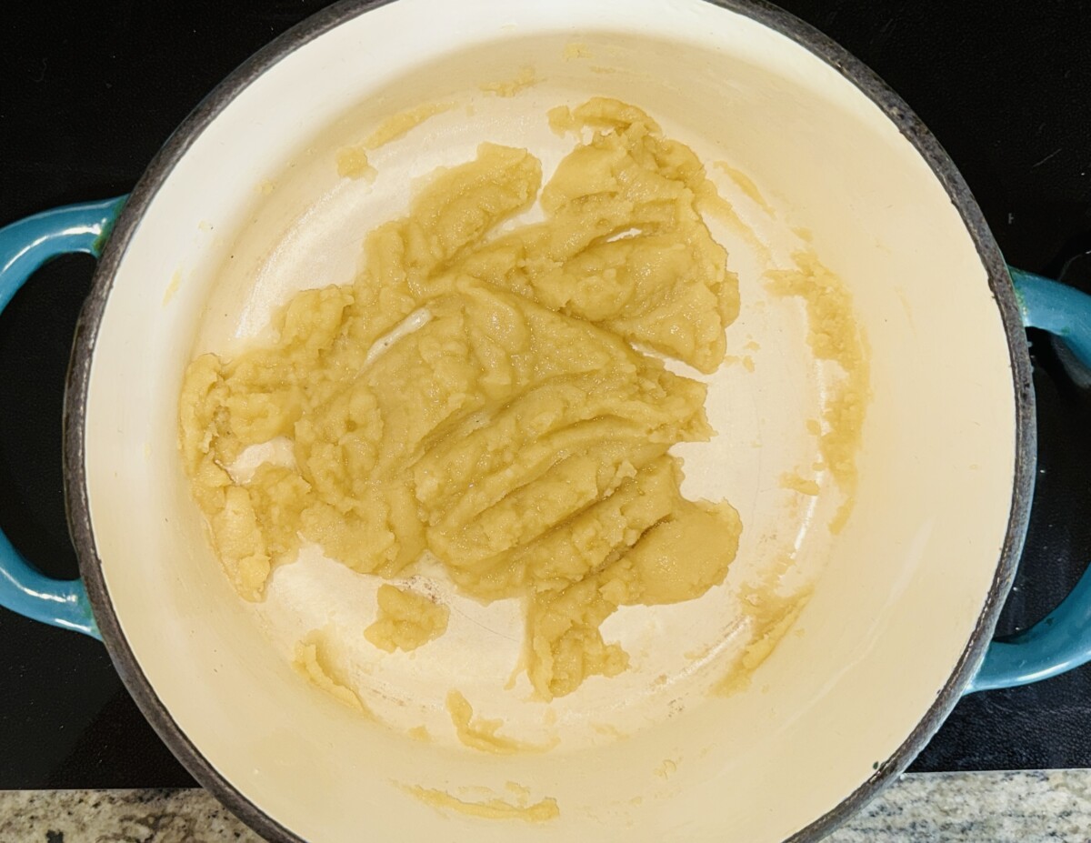 Melting butter and stirring in flour to make the roux for the Greek Pastitsio béchamel sauce.