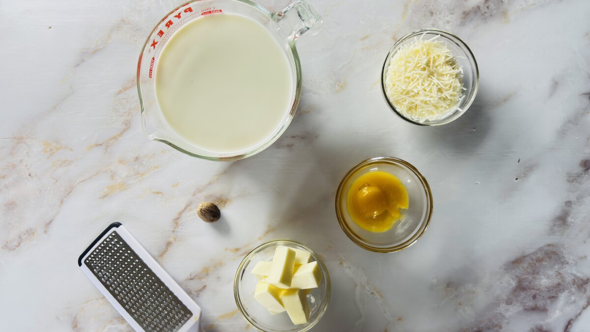 Ingredients for Greek Pastitsio béchamel sauce — butter, flour, milk, kefalotyri cheese, egg yolks, and nutmeg.