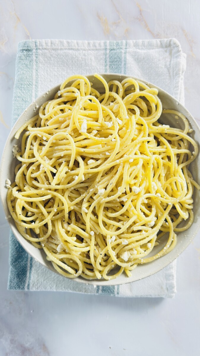 Pasta mixed with feta cheese, egg whites, nutmeg, and black pepper for the Greek Pastitsio pasta layer.