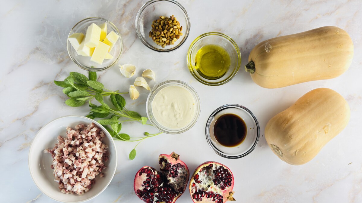 Hasselback butternut squash ingredients with sage, pomegranate, pancetta, and tahini