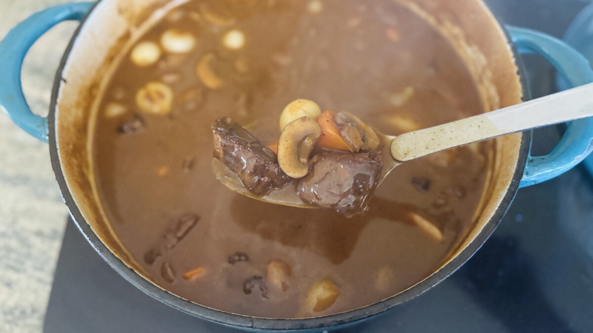 Fork-tender braised beef in rich wine sauce after 2.5 hours of cooking in Dutch oven