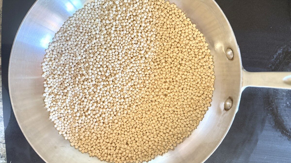 Pearl couscous toasting in a dry pan until golden brown for extra nutty flavor
