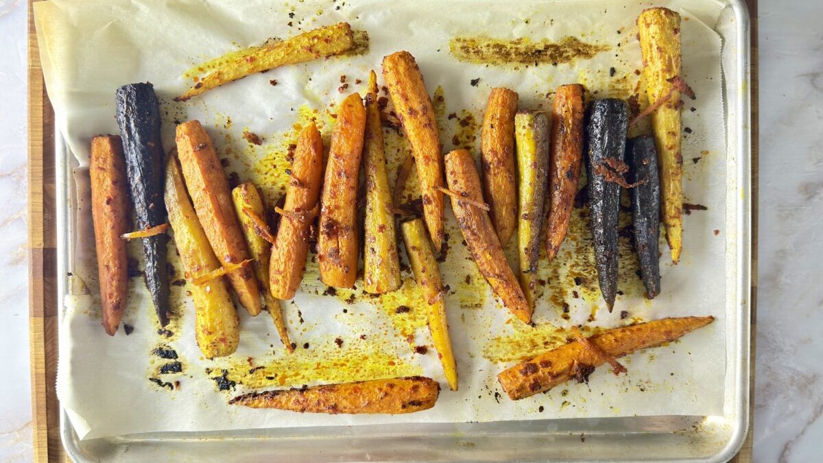 Caramelized harissa roasted carrots with crispy edges fresh out of the oven