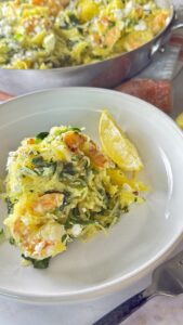 Close up of Mediterranean spaghetti squash with shrimp showing golden feta, fresh dill, and lemon zest