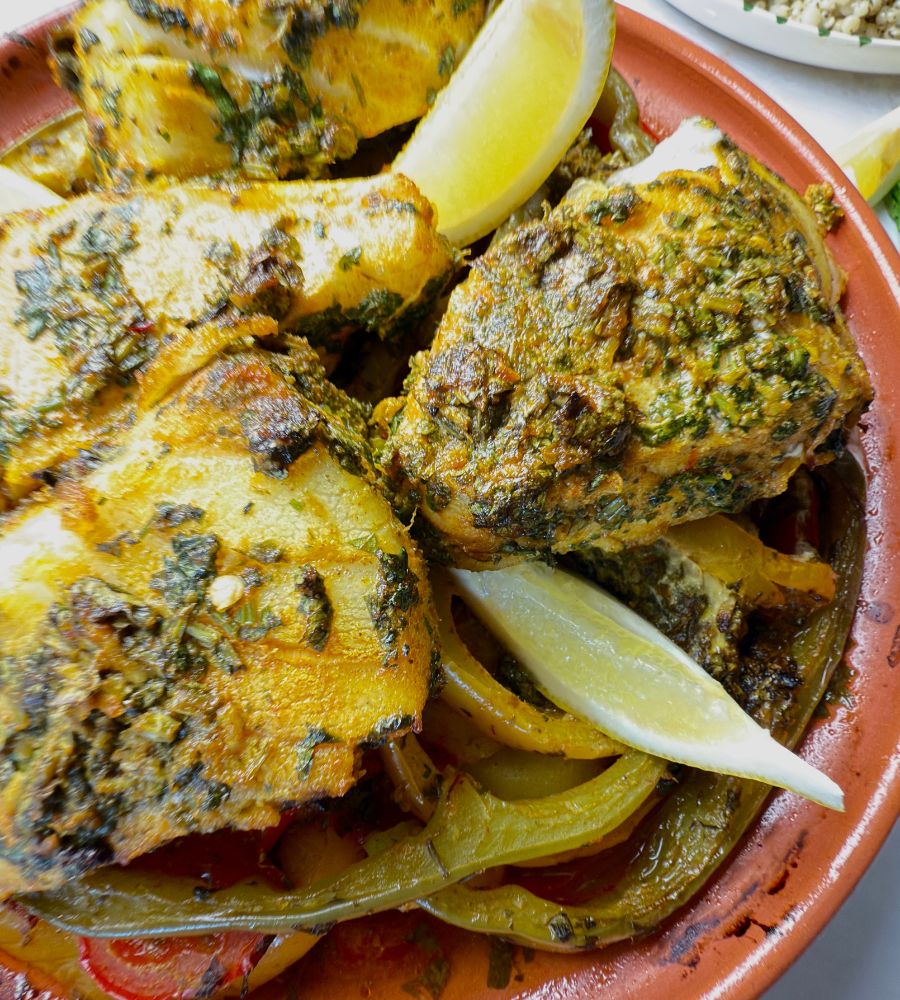 Moroccan fish tagine with chermoula and vegetables in a traditional clay pot